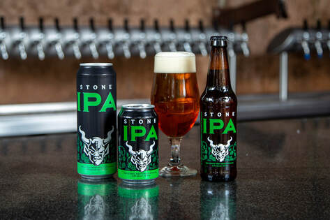 Picture of Stone IPA cans, bottles and glass