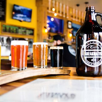 Picture of Breakwater Brewing Co. growler and beer flight with menu