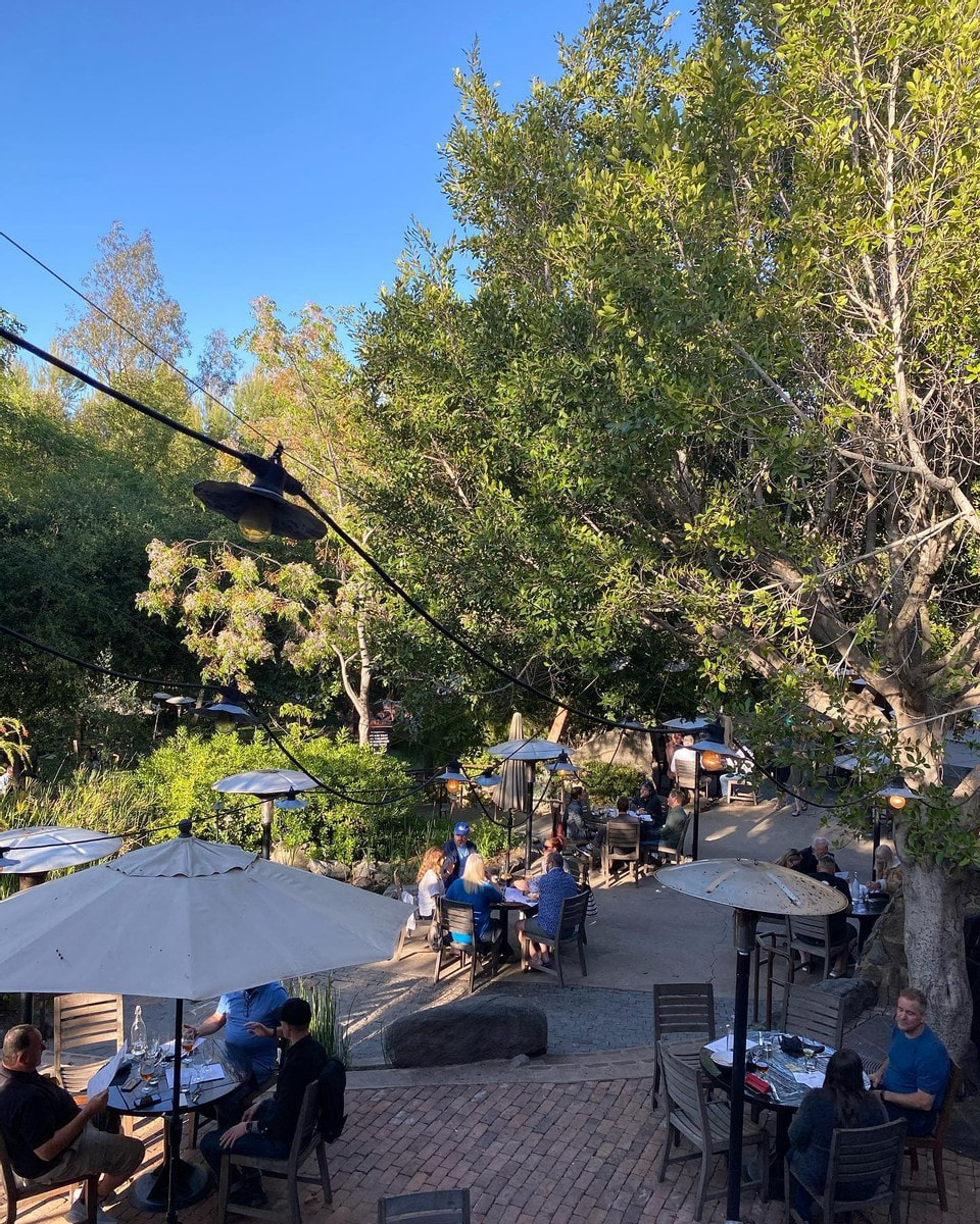 Photo of Stone Brewing Escondido outdoor patio with guests seated at tables