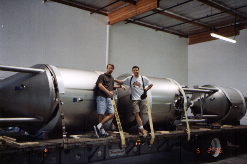 Photo of Greg Koch and Steve Wagner with fermentation tanks