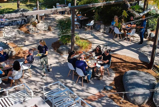 Picture of outdoor seating space with people at Alpine Beer Co. Outpost