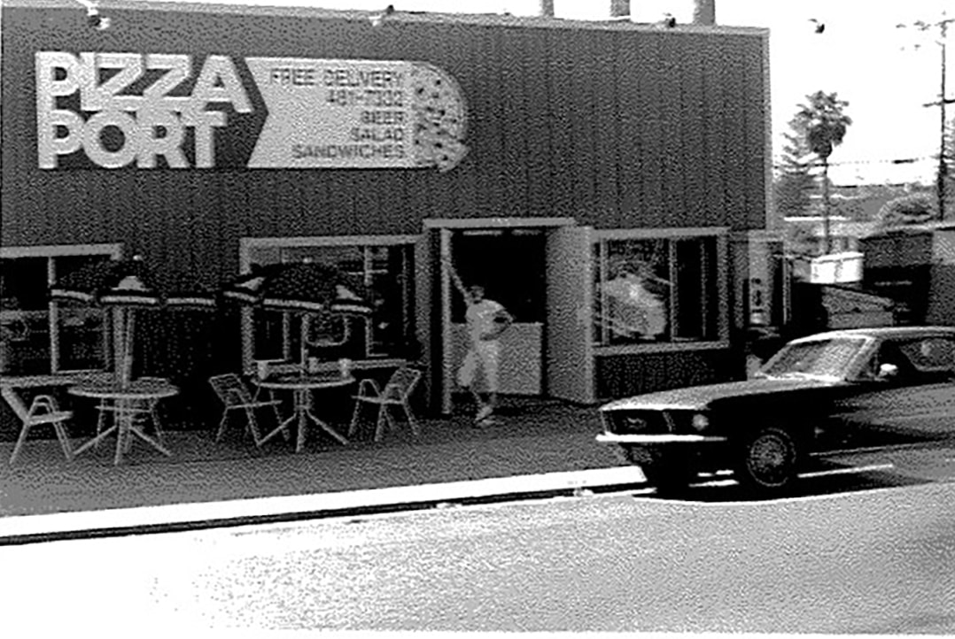 Picture of Gina Marsaglia in front of original Pizza Port location