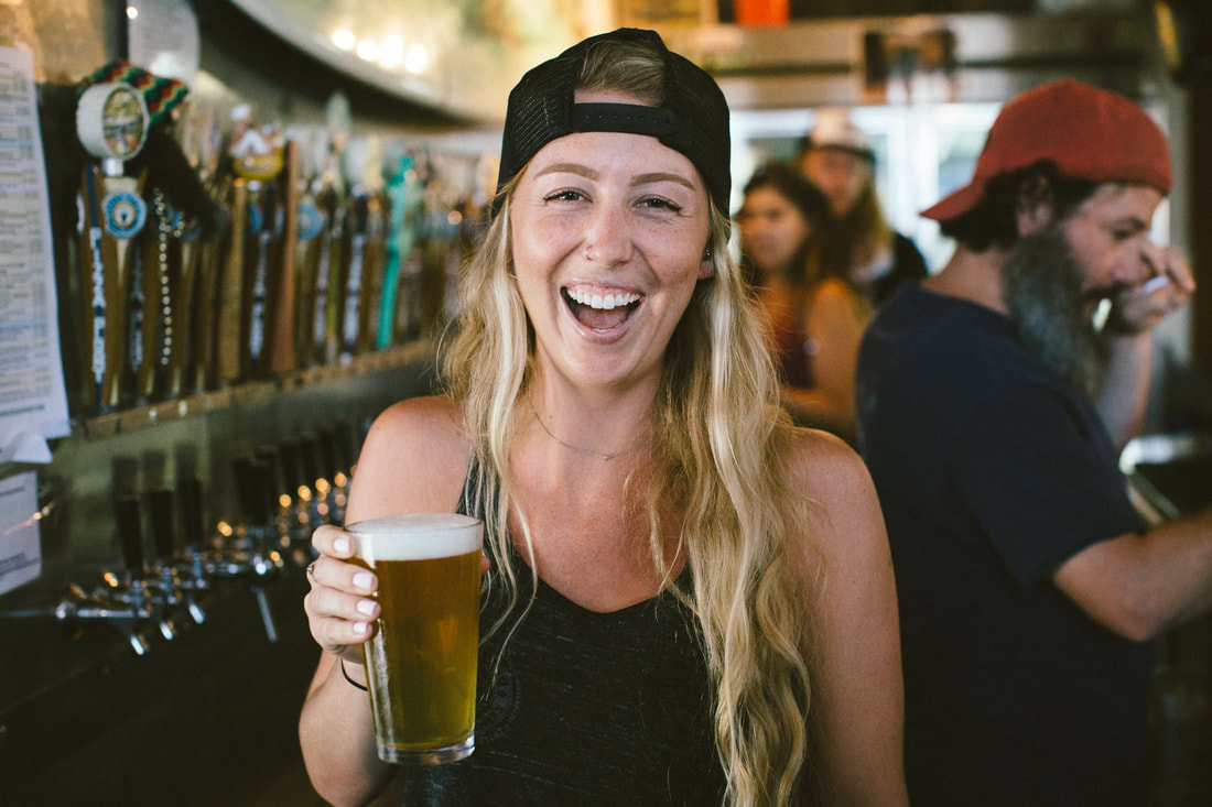 Woman smiling holding a beer