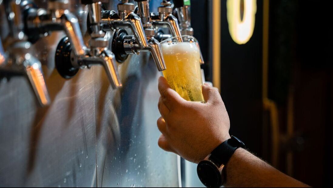 Picture of beer being poured into glass from tap