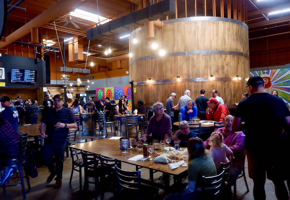 Photo of people in Wild Barrel Brewing tasting room eating and drinking